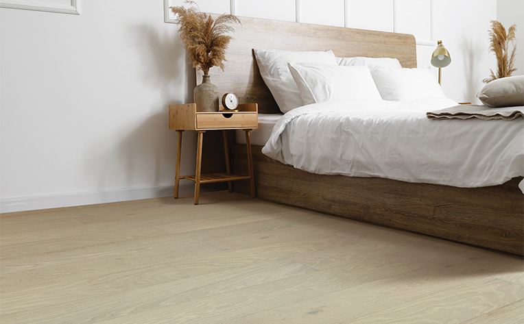 light toned wide plank hardwood flooring in bedroom