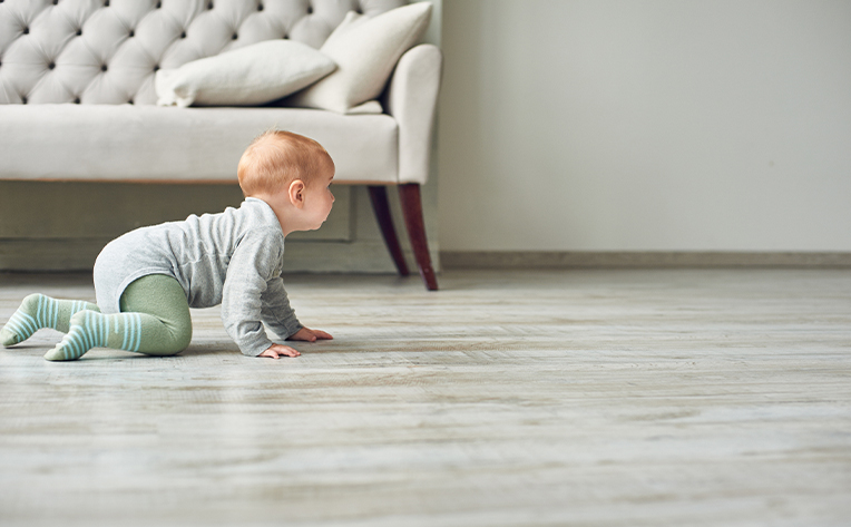sheet vinyl floor with grey couch